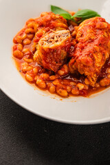 Stuffed cabbage tomato sauce with beans meat, cabbage, fresh delicious gourmet food background on the table rustic food top view copy space