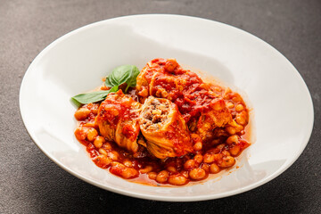 Stuffed cabbage tomato sauce with beans meat, cabbage, fresh delicious gourmet food background on the table rustic food top view copy space