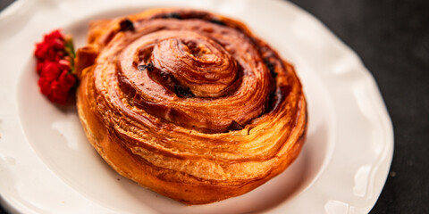 Raisin bun sweet pastry dessert puff pastry fresh delicious gourmet food background on the table rustic food top view copy space
