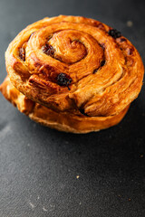 Raisin bun sweet pastry dessert puff pastry fresh delicious gourmet food background on the table rustic food top view copy space