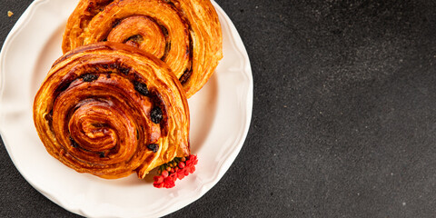 Raisin bun sweet pastry dessert puff pastry fresh delicious gourmet food background on the table rustic food top view copy space