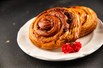 Raisin bun sweet pastry dessert puff pastry fresh delicious gourmet food background on the table rustic food top view copy space