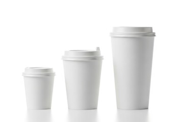 Three white paper coffee cups of different sizes isolated on white background