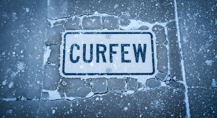 Imposed Time Curfew Sign Surrounded by Ice and Frozen Conditions Outdoor