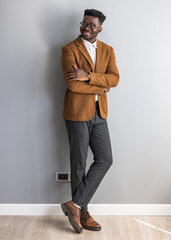 Confident Young Professional in Stylish Attire Against Minimalist Background