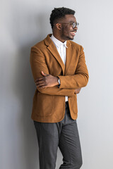 Confident Professional Smiling in Stylish Brown Suit With Folded Arms