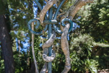 Roots on a metal fence in Achilleion mansion, called Sisi Palace, Corfu Island in Greece