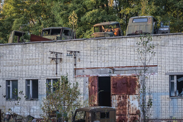 Old vehicles on the roof of abandoned police station in Pripyat ghost city in Chernobyl Exclusion Zone, Ukraine