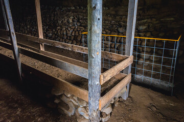 Inside the turf shed for sheeps in historical Hjardarhagi farm in Iceland