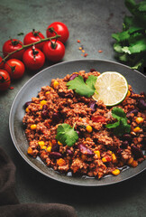 Mexican Chili dish with minced beef, beans, paprika, corn, cilantro, jalapeno pepper in tomato sauce, top view