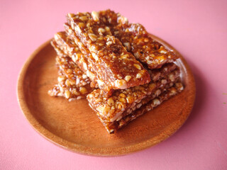 Indonesian traditional snack called enting-enting or ting-ting kacang. This snack made of peanut and brown sugar, served on a plate. Top view