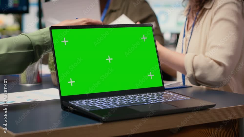Poster team of businesswomen creates a strategy next to chroma key display with big tv monitor open and pla