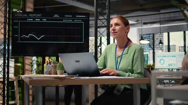 Confident entrepreneur blending digital data tools with strategic thinking to align business goals with the strategy, demonstrating empowered leadership for an enterprise. Camera A.