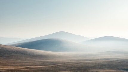 Fototapeta premium Rolling hills are covered in morning mist and diffused sunlight