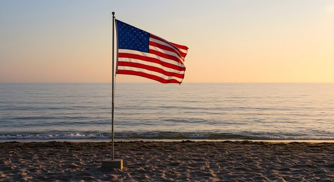 American flag waving at beach during sunset