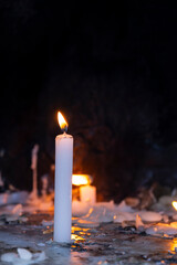 Candle lighting area in a church. Spiritual atmosphere. Prayer candles burning inside a historic...