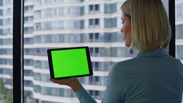 Financier reading data green screen tablet in corporate office space closeup. - Powered by Adobe