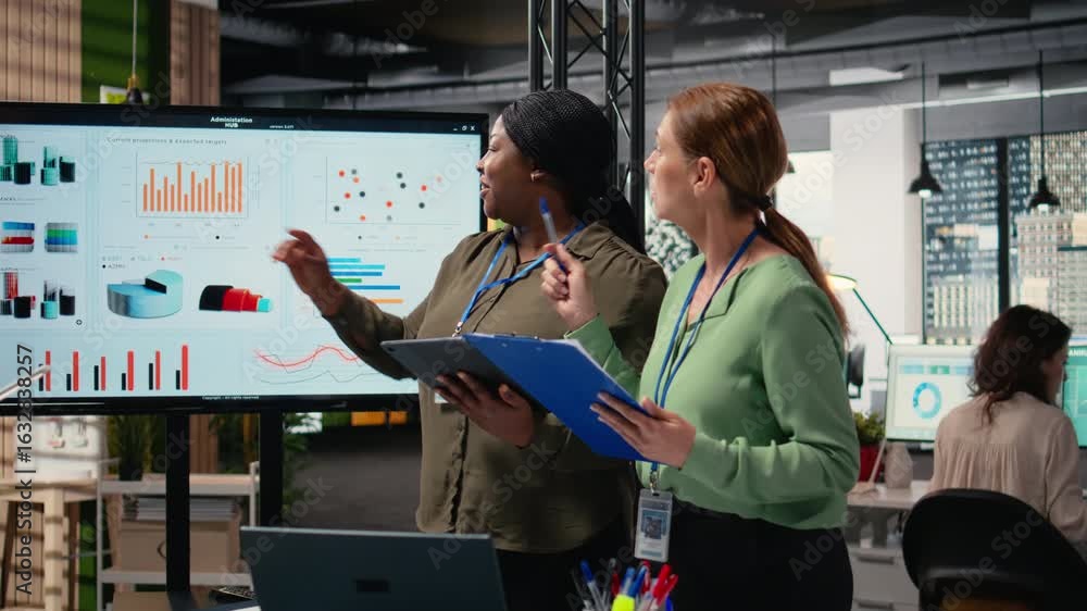 Aufkleber multiethnic businesswomen uniting to review finance reports and analytics in a dynamic work environm