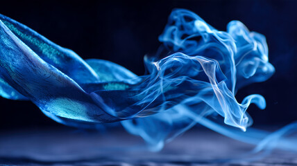 Abstract blue silk and ethereal smoke dance in a captivating display of texture and movement against a dark, mysterious backdrop.