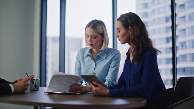 Bank clients signing deal after financial advisor consultation at modern office.