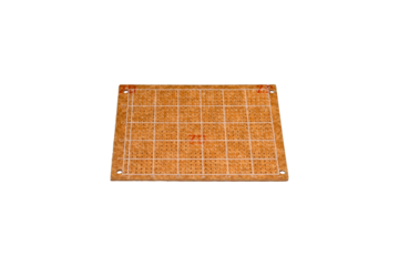 Grid-labeled prototyping board with perforated surface is isolated.