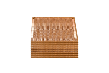 Stack of copper prototyping boards with perforated layout is isolated.