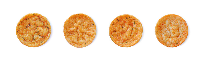Spicy rice chips with paprika and basil isolated on white background top view