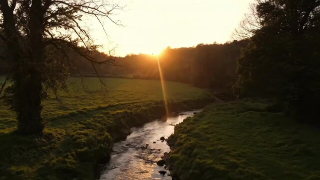 sunpath - A weathered stone bridge covered in moss spans a tranquil stream, surrounded by lush greenery and trees under a soft sunset, evoking a sense of peace and natural beauty