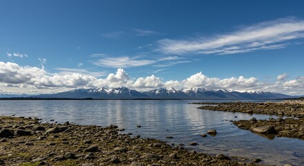 a body of water with mountains in the background