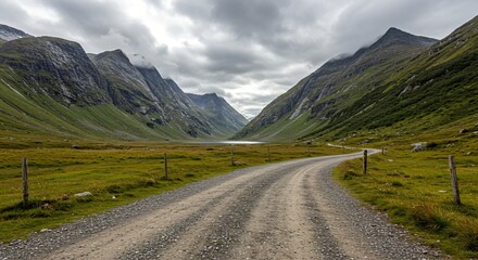 Fototapeta premium a gravel road in the middle of a mountain valley