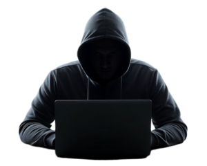 Man in hoodie using laptop in dark setting with obscured face and silhouette against black background