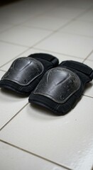 Black knee pads on tile