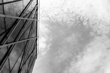 Contemporary glass building facade with geometric metal framework is shown on the left, contrasted...