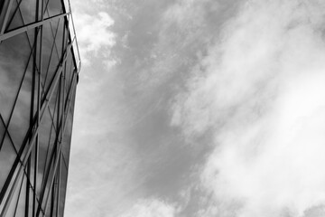 A contemporary glass building with geometric metal framework is shown on the left, contrasted by a...