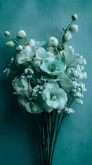 Delicate white and mint green flowers bloom against a soft teal background, creating an ethereal and serene botanical composition of elegant floral beauty
