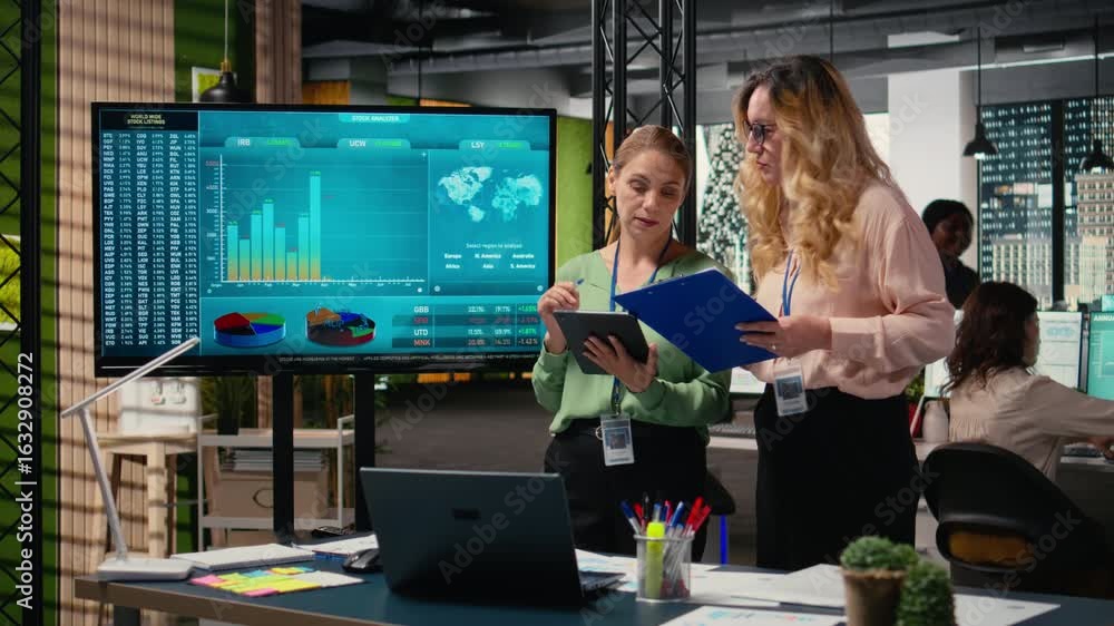 Poster goals oriented businesswomen representing strategic collaboration in the office, using tablet and da