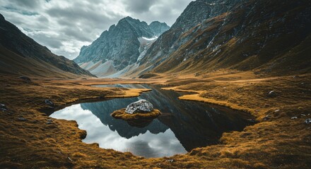 a small pond in the middle of a mountain