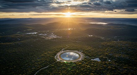 the sun is setting over a lake in the middle of a forested area