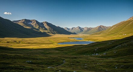 a view of a valley with a lake and mountains in the background