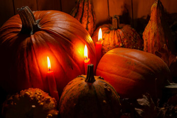 Pumpkins and Candles for Autumn Celebration.lots of pumpkins in the light of red candles.Pumpkin...