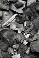 Pieces of black coals as background, top view
