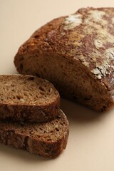 Pieces of fresh rye bread on beige background, closeup