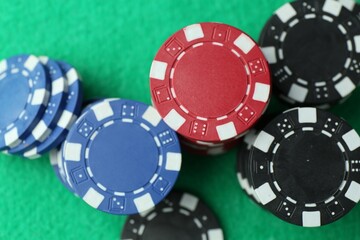 Casino chips on green table, flat lay