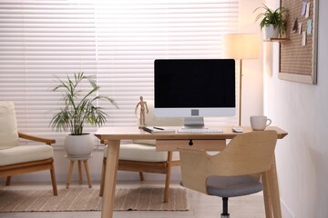 Stylish workplace with wooden desk, computer and stationery at home office. Interior design