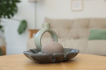 Beautiful vases on wooden table in living room, closeup