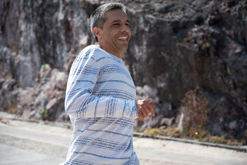 Smiling Man Jogging Outdoors on Sunny Day
