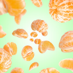 Sweet tangerines whirling in air against aquamarine gradient background