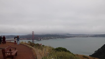 Winding path on Marin Headlands hillside, view of Golden Gate Bridge and San Francisco Bay, lush greenery and forest
 - Powered by Adobe