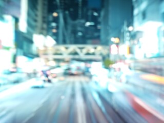 Abstract bokeh image of Hong Kong city at night, with blurred lights and silhouettes.