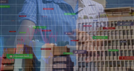 Analyzing two colleagues in striped shirts using digital interface in office, showing media metrics